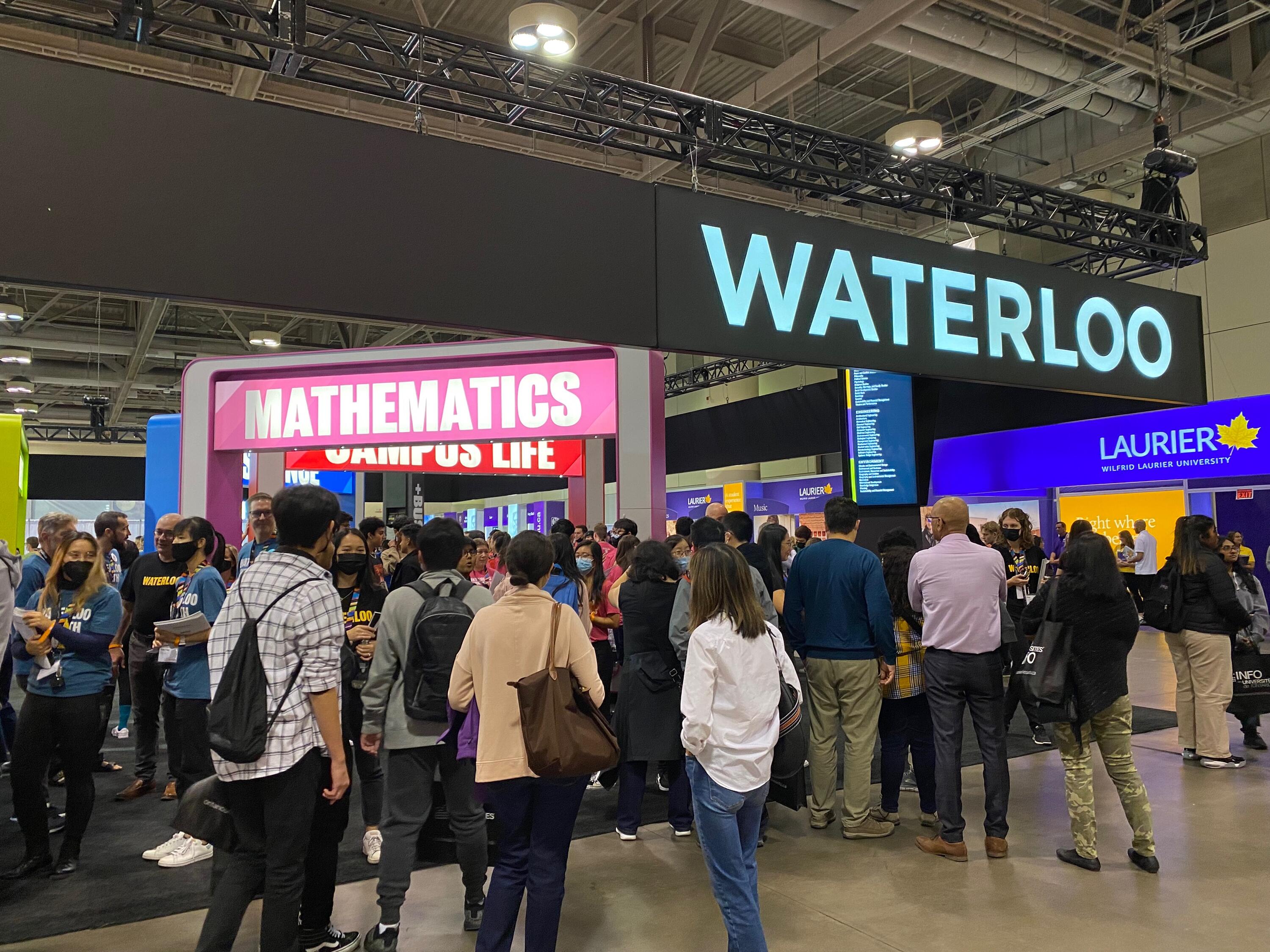 Visitors crowd around the Waterloo Mathematics booth
