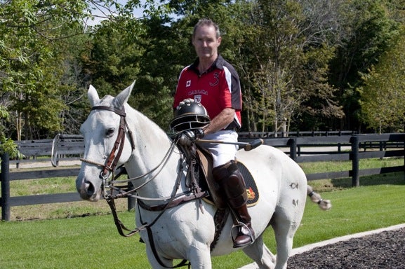 Mike Egan riding on a white horse