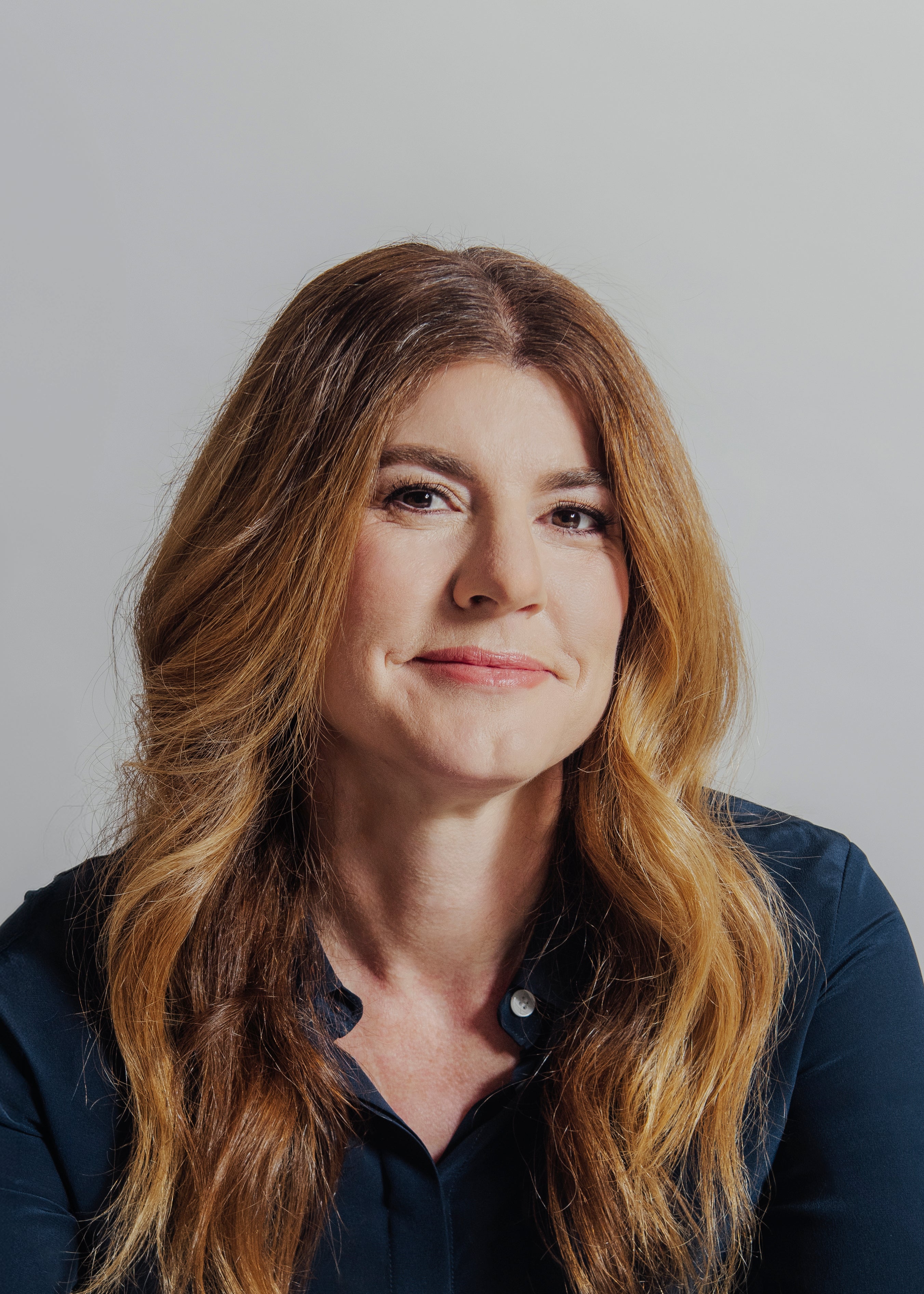 headshot of woman with long hair smiling