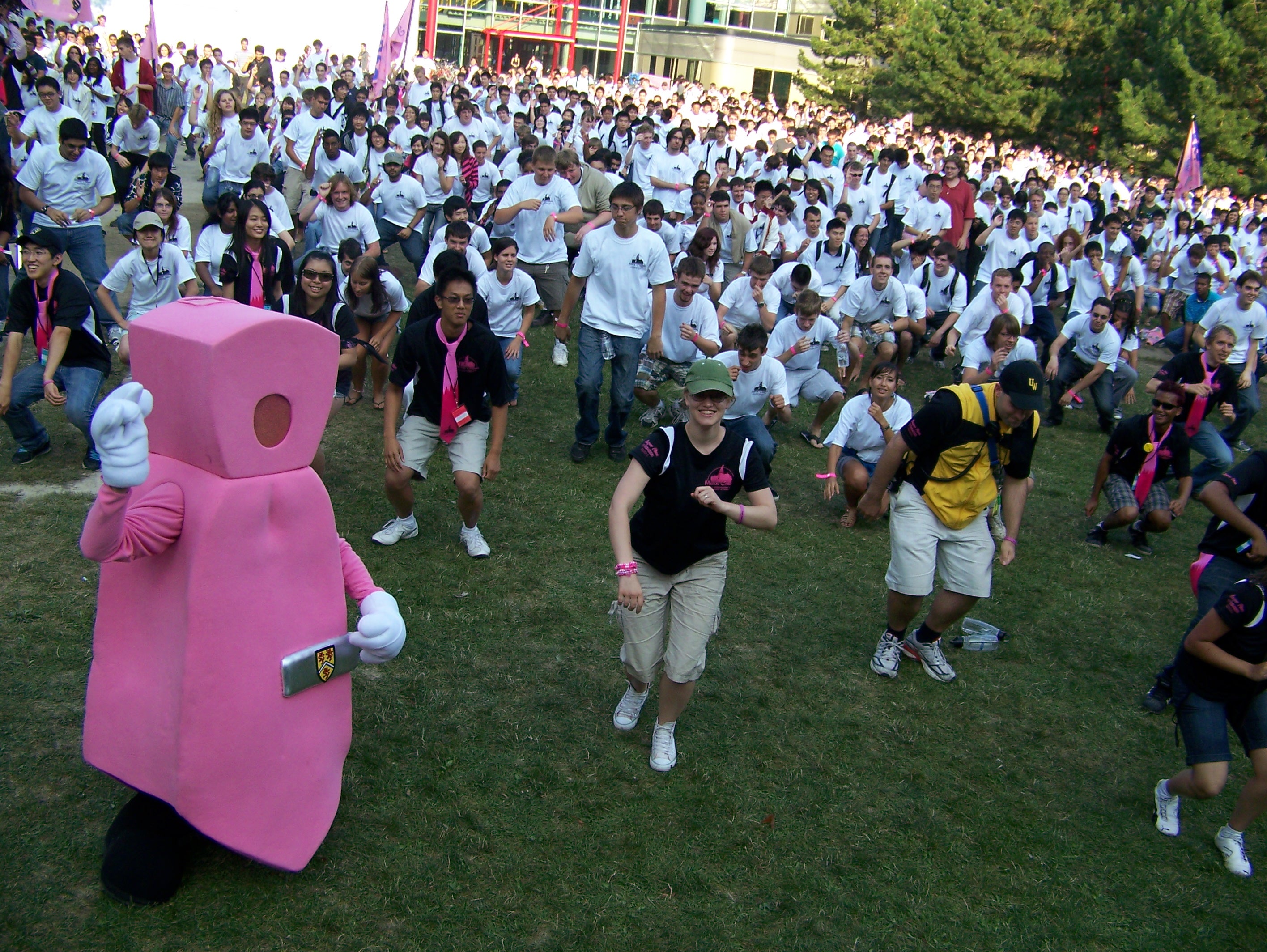 Pinkie the pink tie mascot dances with first year students