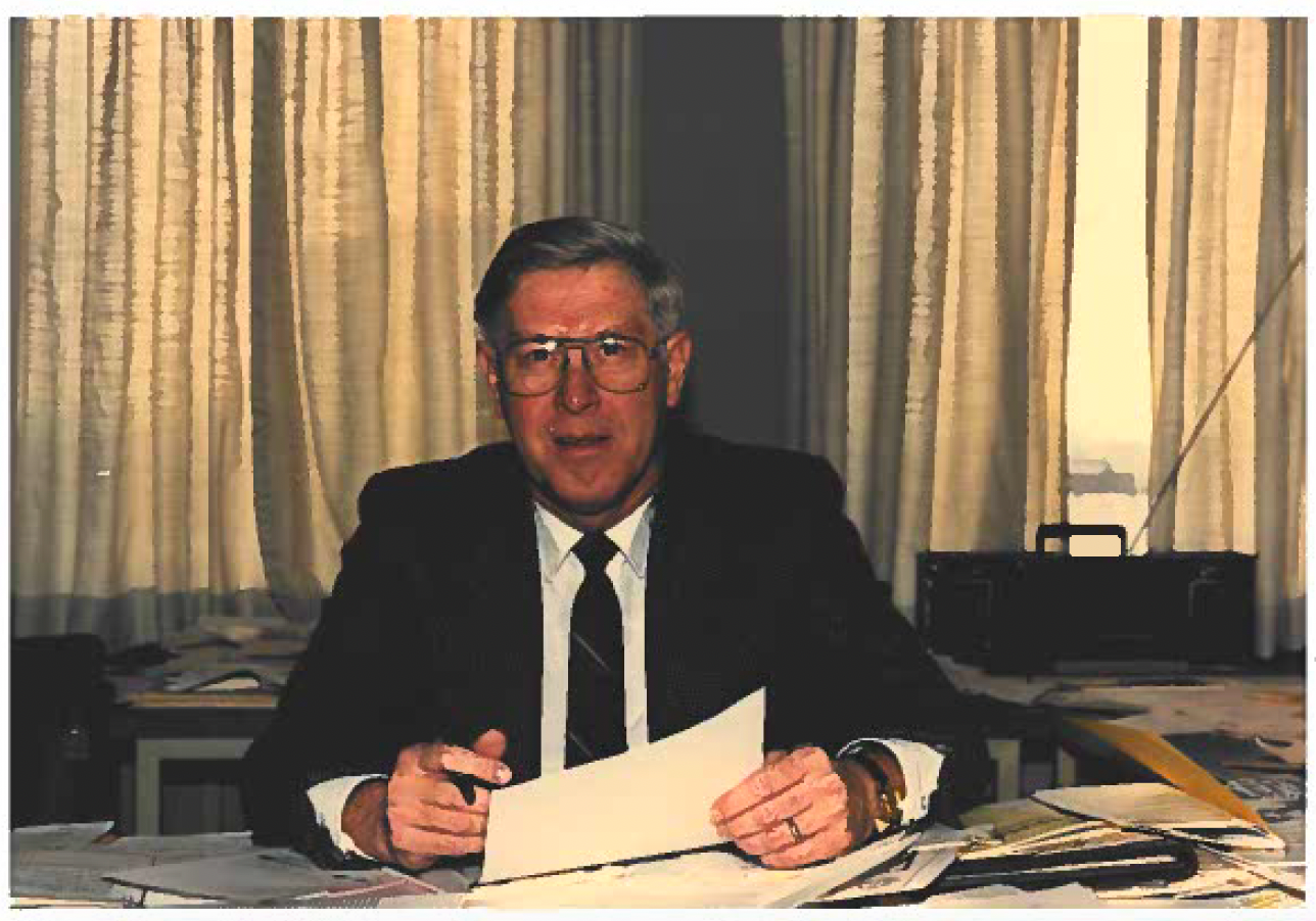 Ron Dunkley sitting at a desk with a piece of paper