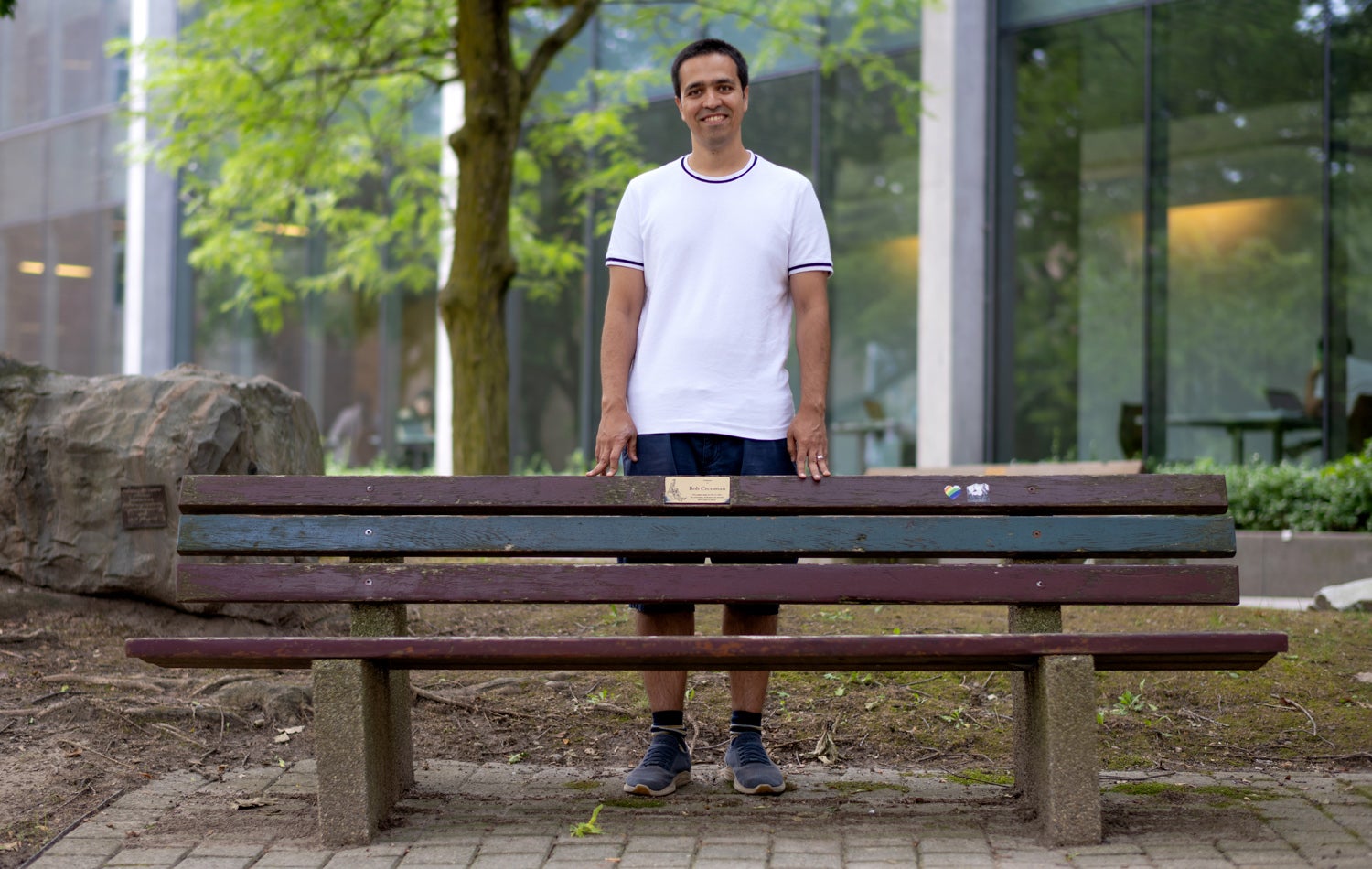 Sepehr Assadi stands behind a bench