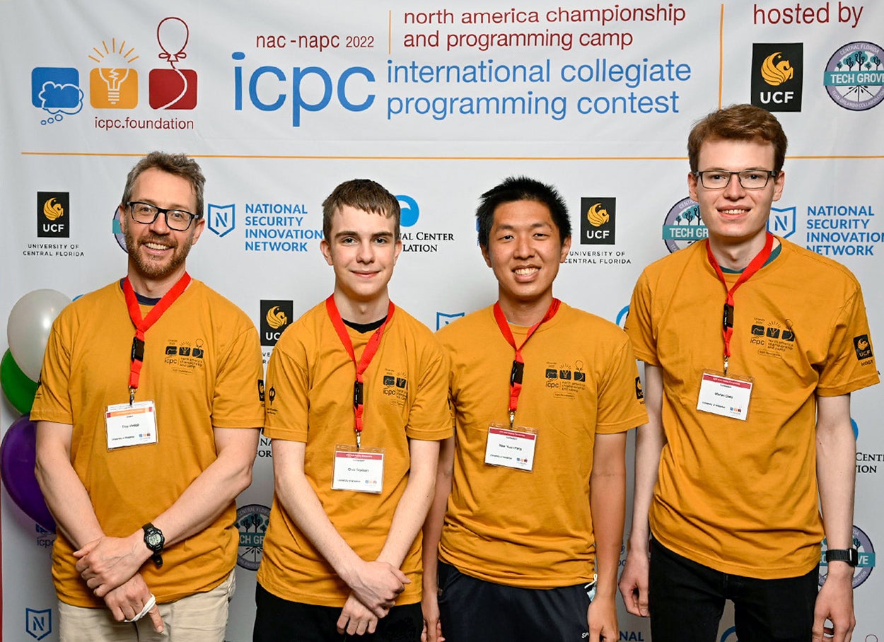 Computer science students and coach at ICPC contest