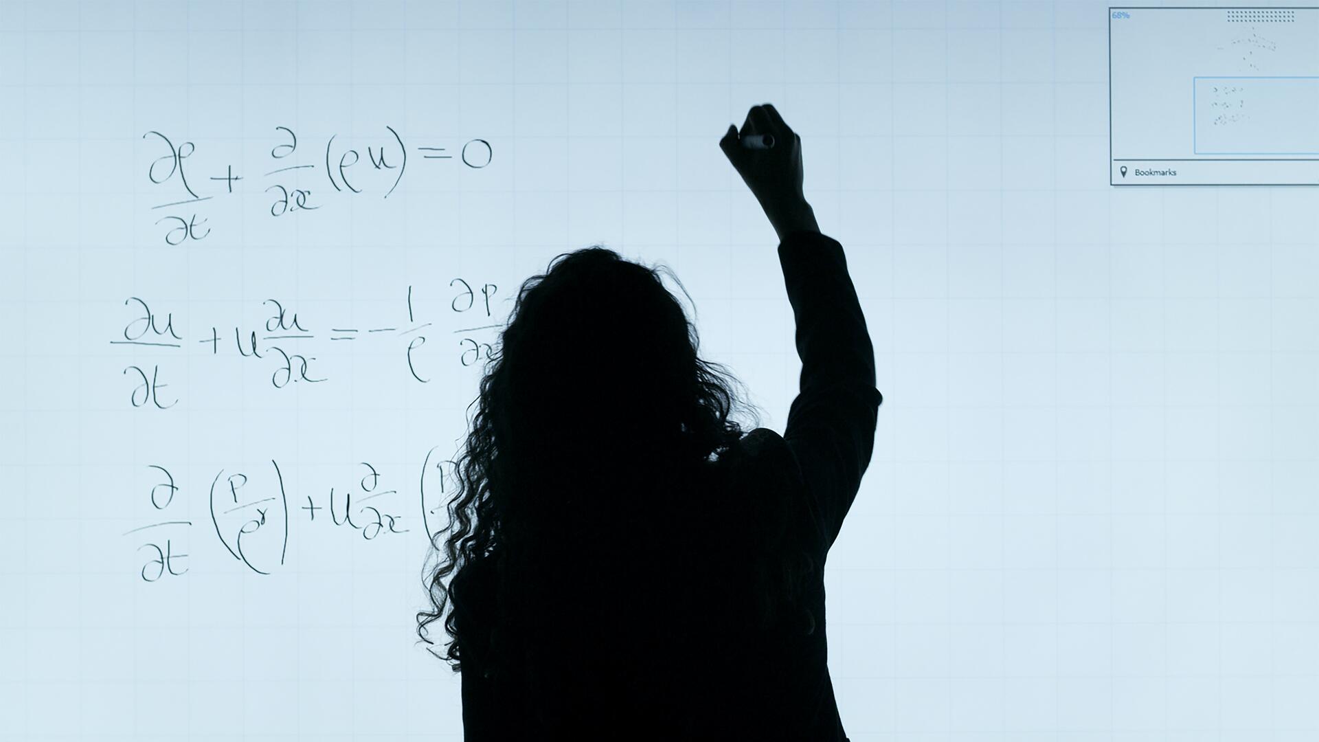 woman writing on a white board