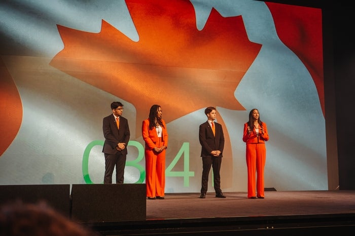Safi members on stage in front of Canadian flag 