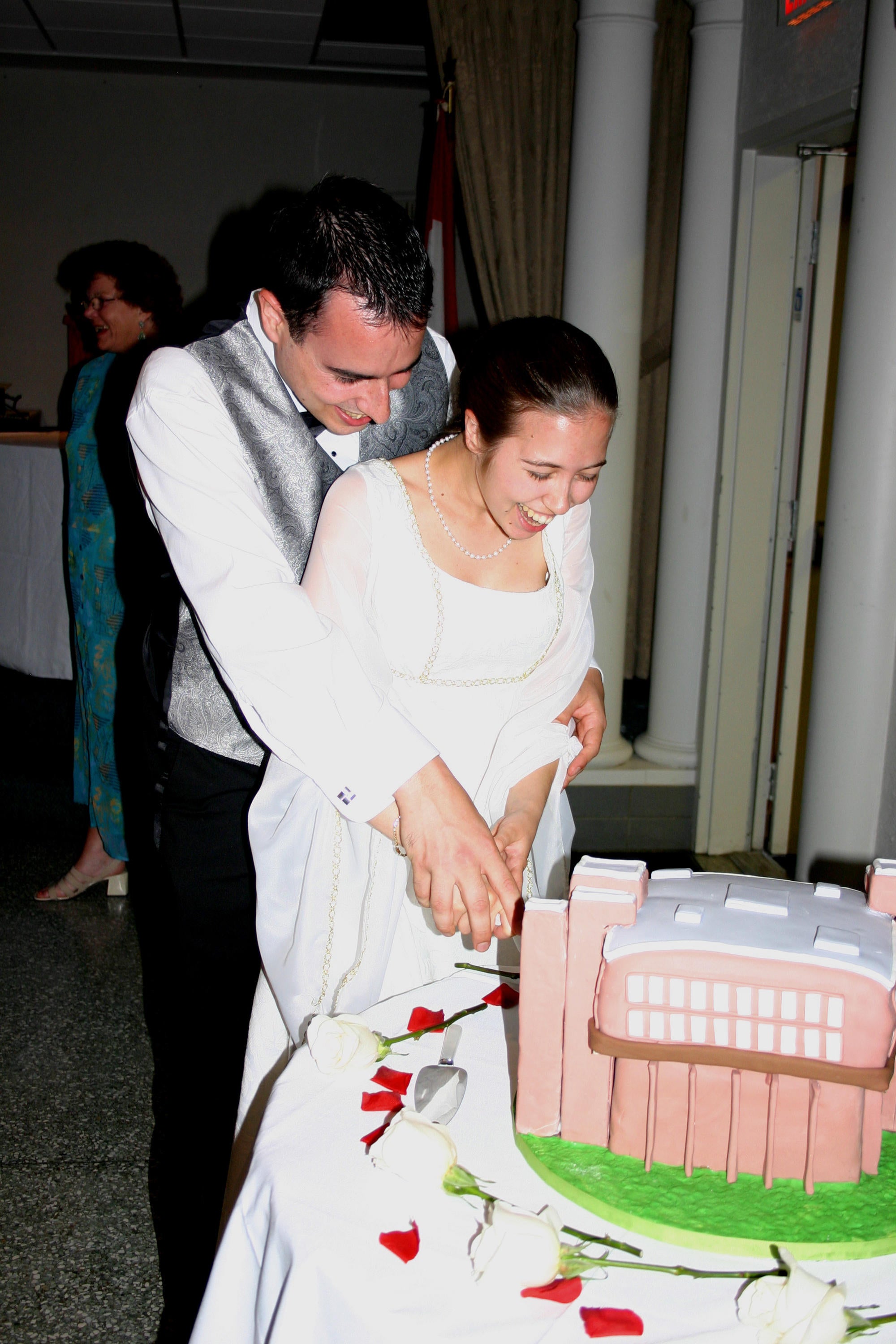 Bride and groom cut a cake model of MC 