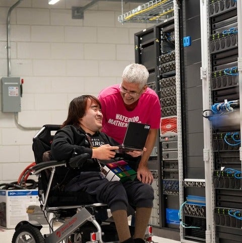 Martin Karsten and Peter Cai talk in a server room