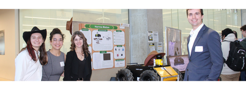 Portrait of 4 students standing wit their capstone project
