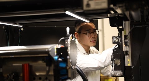 Student studying materials science and additive manufacturing in a lab setting