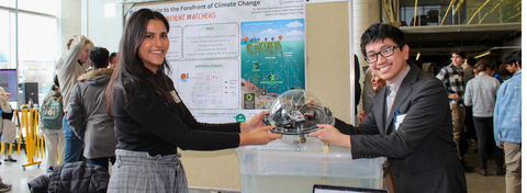 2 students holding up their capstone design project