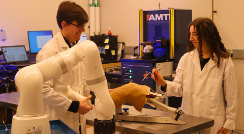 Student and professor working with technology for health care applications