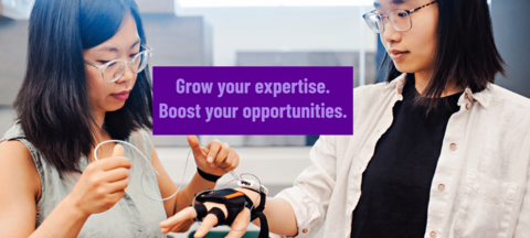 Student and professor working with robotics in a lab