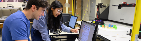 Students working with robotic systems