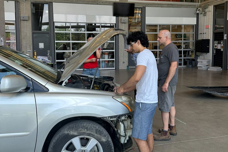 Student working on car