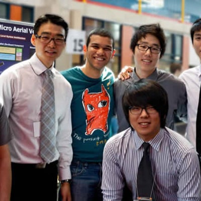 six men smiling for the camera