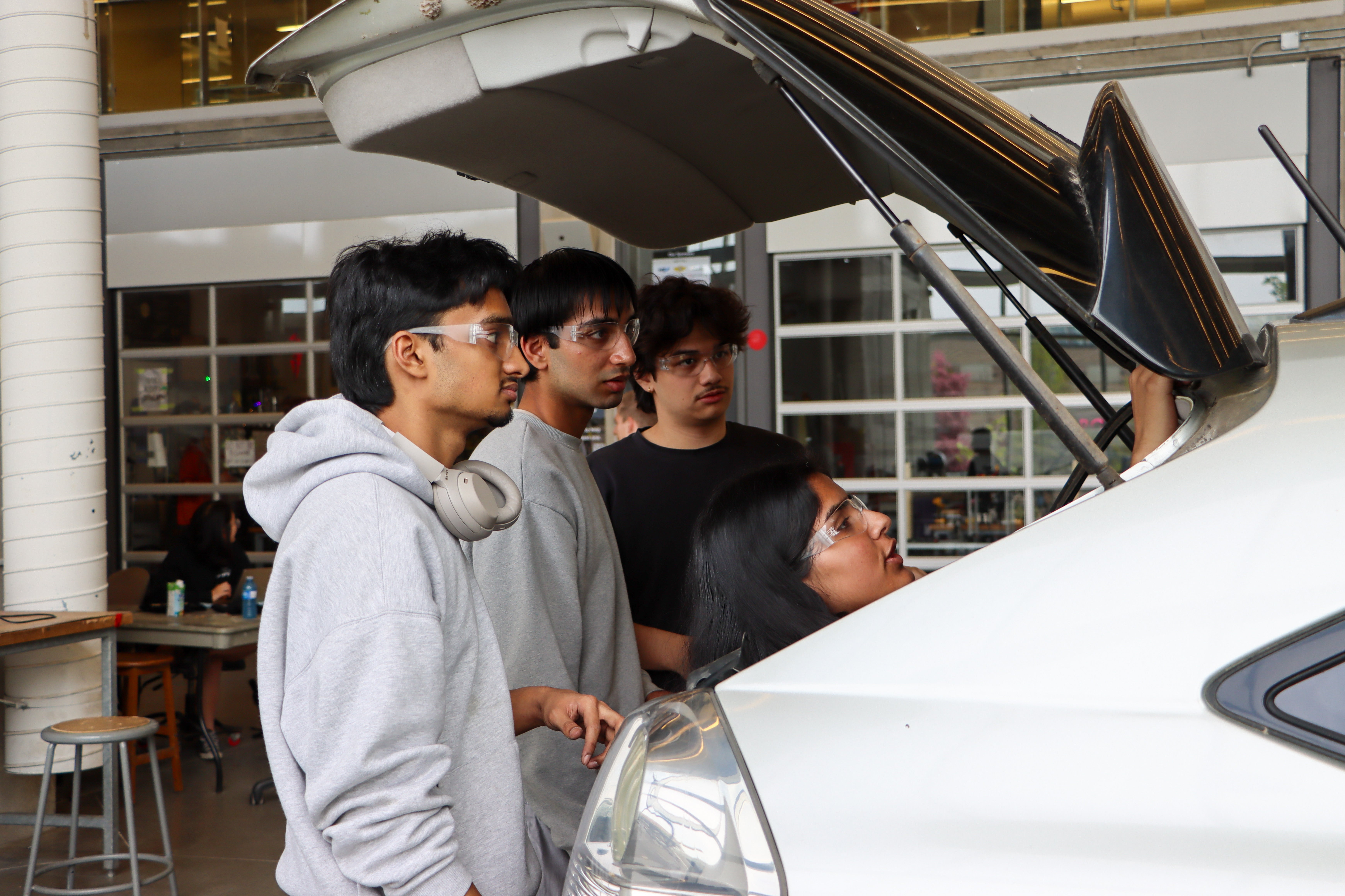 Students taking off the trunk of a car