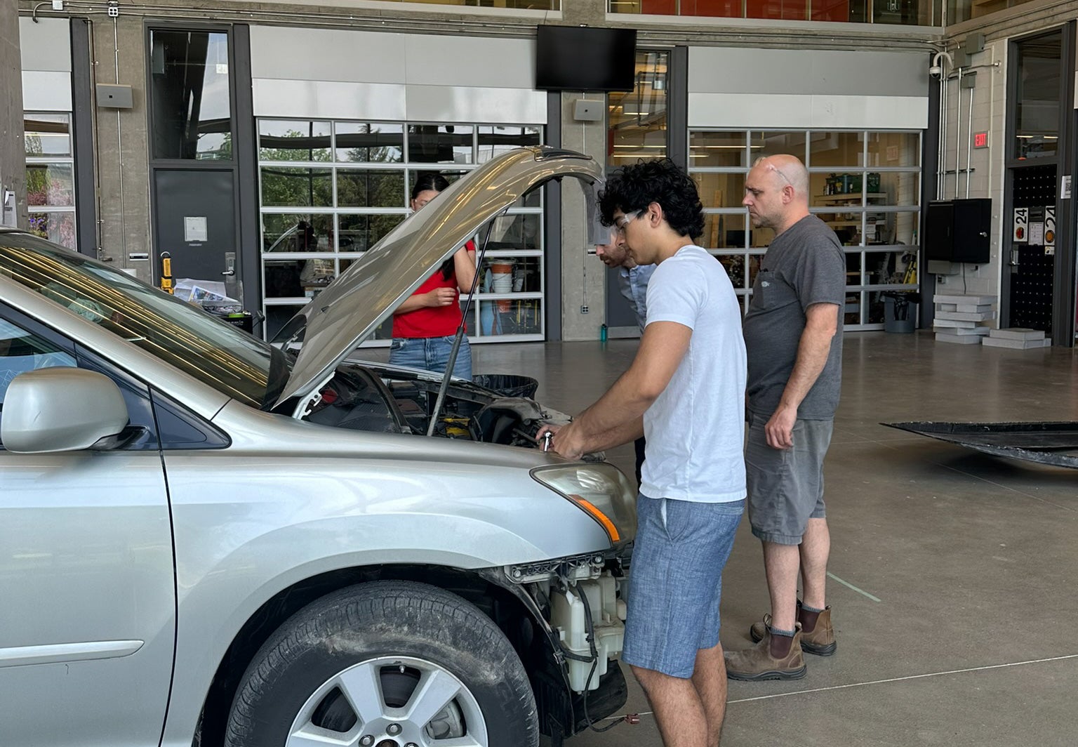 Student working on car