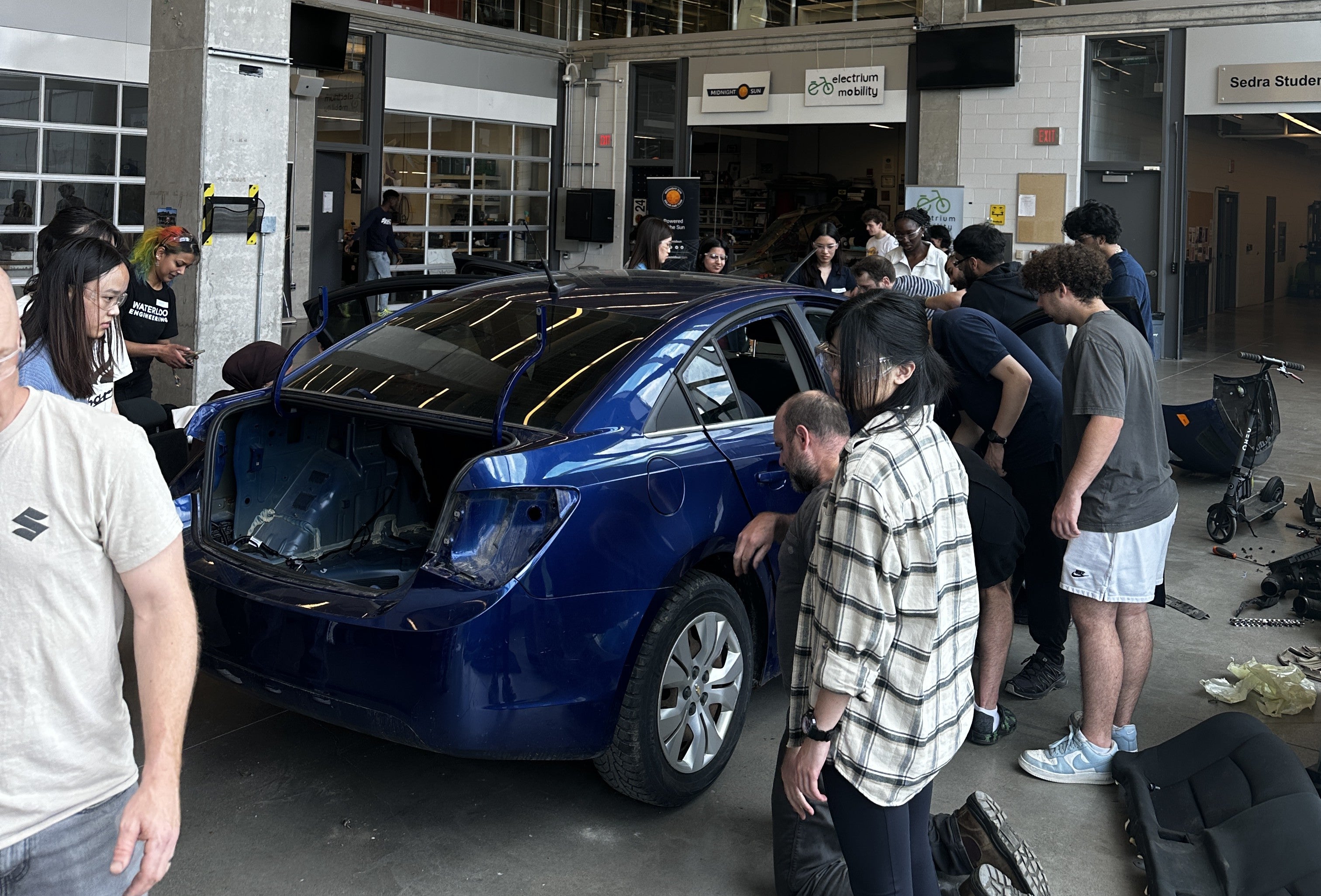 Students taking apart a car