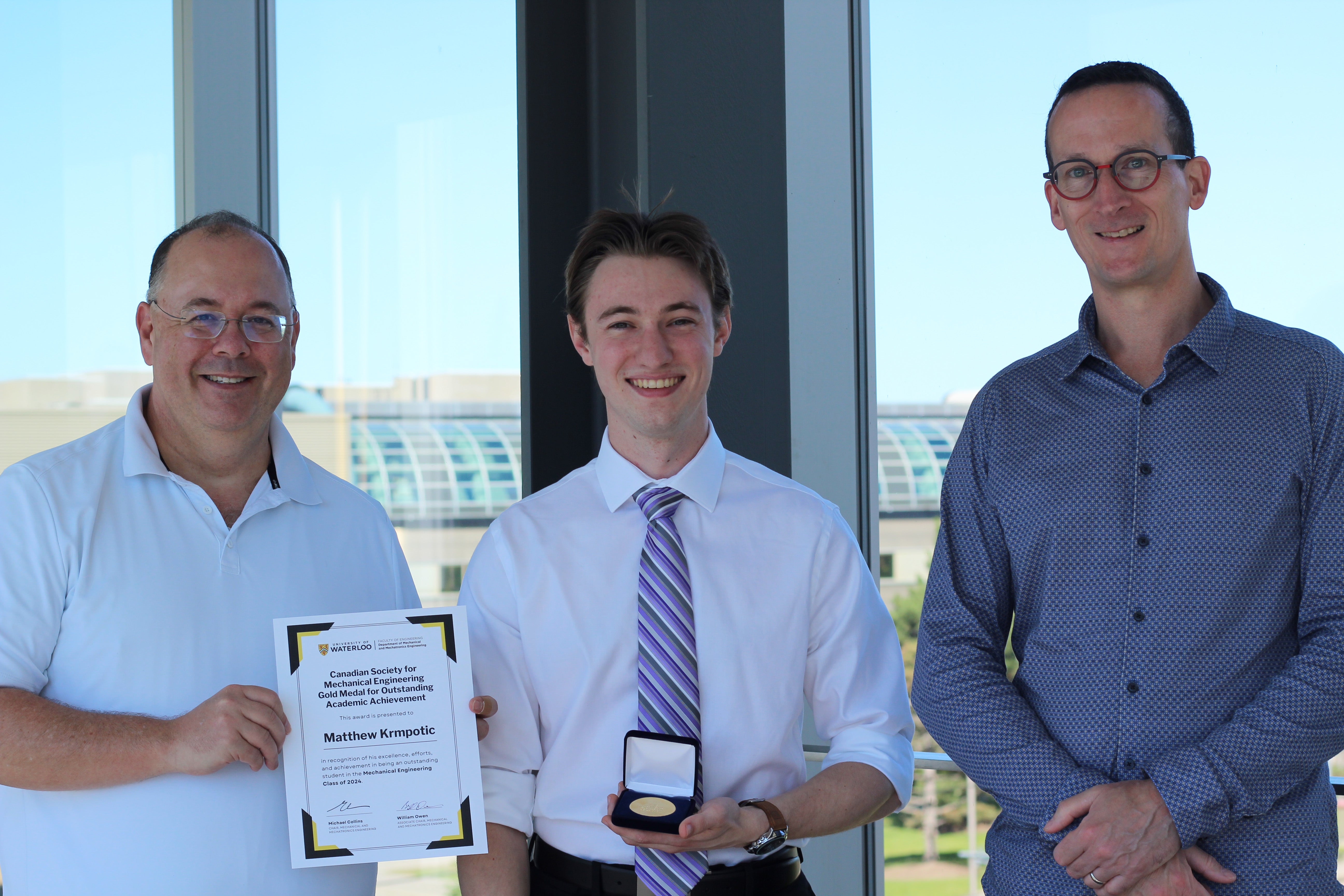 Matthew Krmpotic standing with Mike Collins and Bill Owen. 