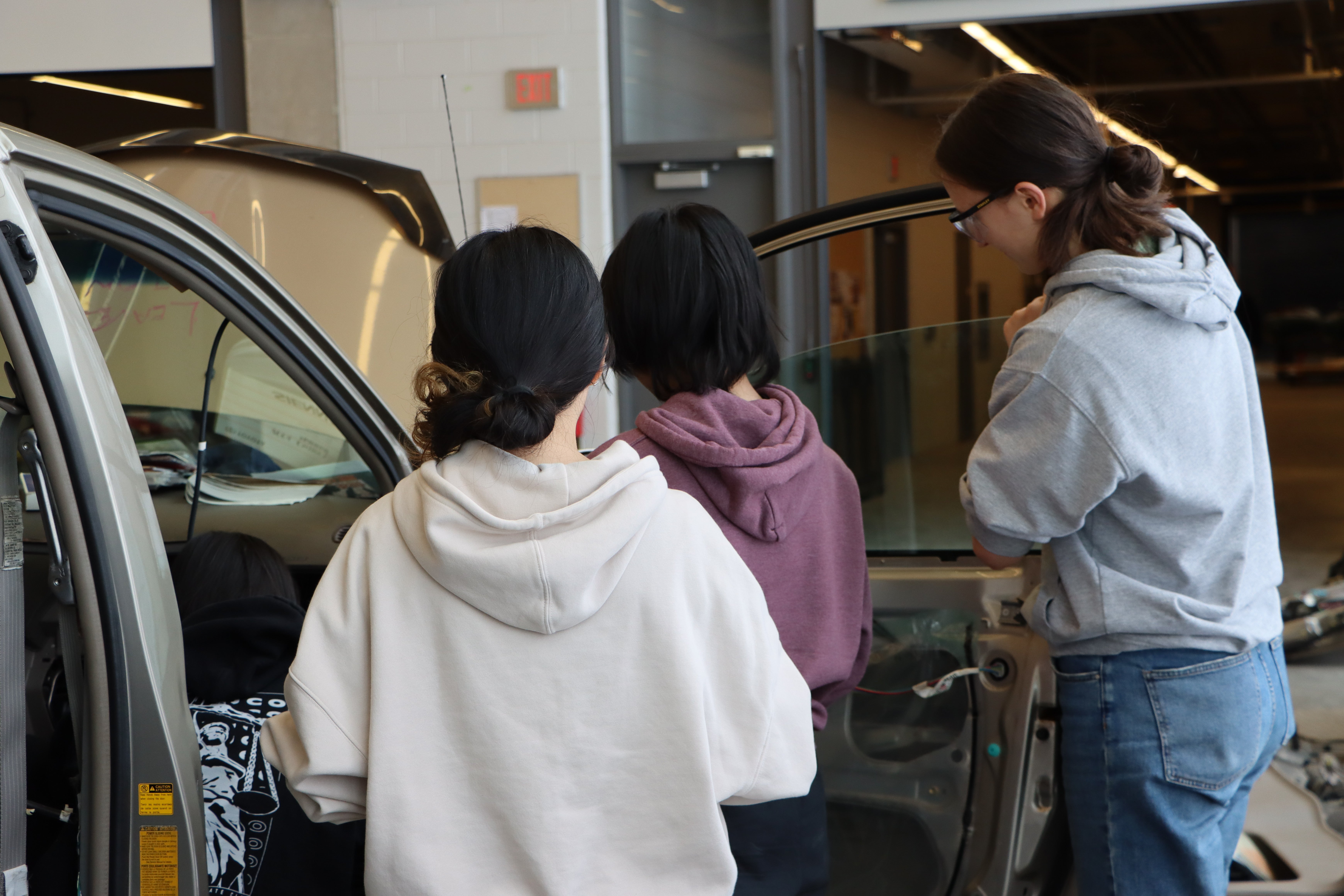 Students taking out the interior of a minivan. 