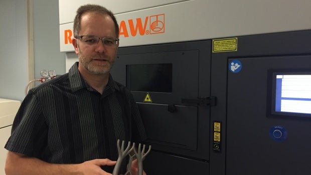 Mark Barfoot, managing director at the Multi-Scale Additive Manufacturing Lab at the University of Waterloo holds a sample 3D-pr