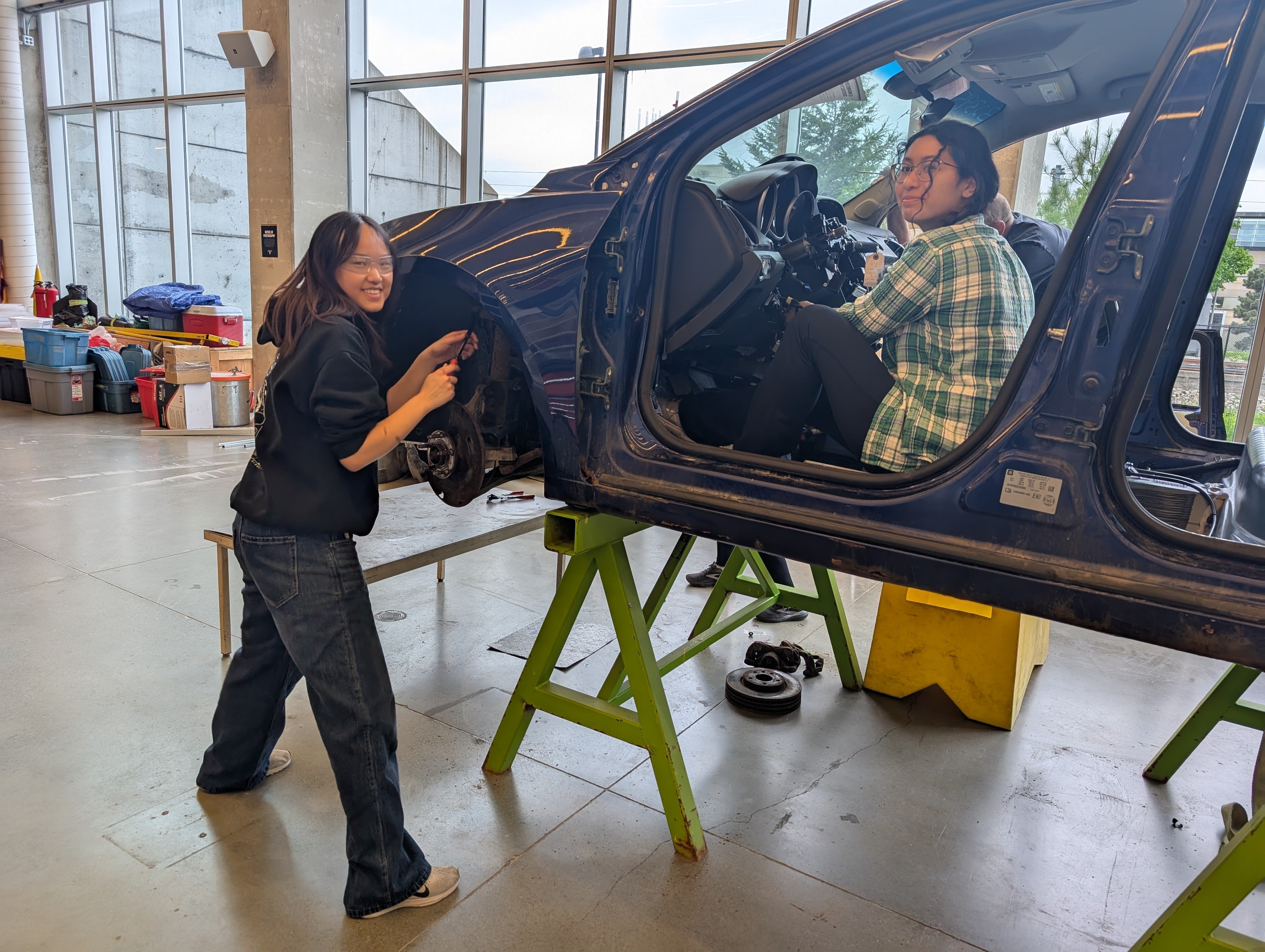 Students taking apart a car
