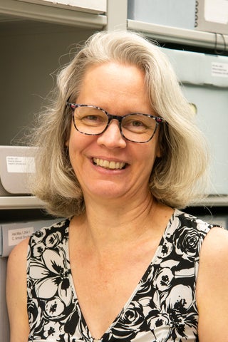 Laureen stands in the archives