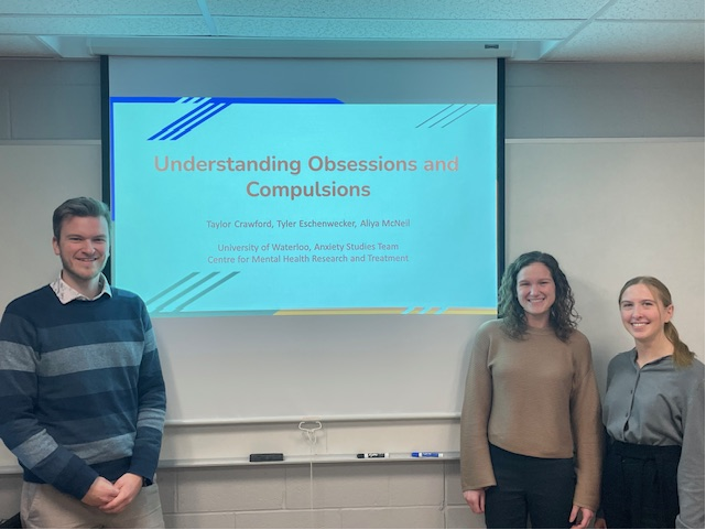 Students standing in front of presentation screen. Left to right: Tyler Eschenwecker, Aliya McNeil, and Taylor Crawford.