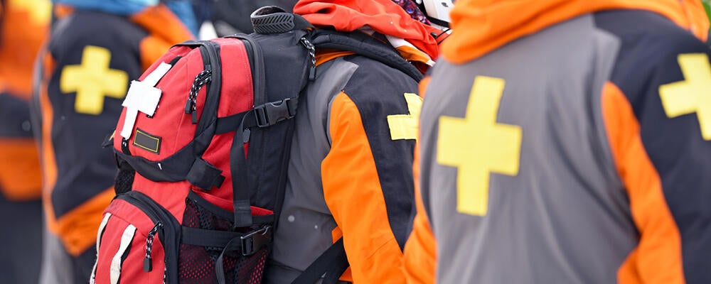First aid responders wearing backpacks