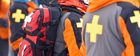 First aid responders wearing backpacks