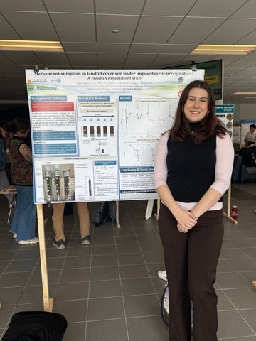 Tara Ferguson in front of her research poster.