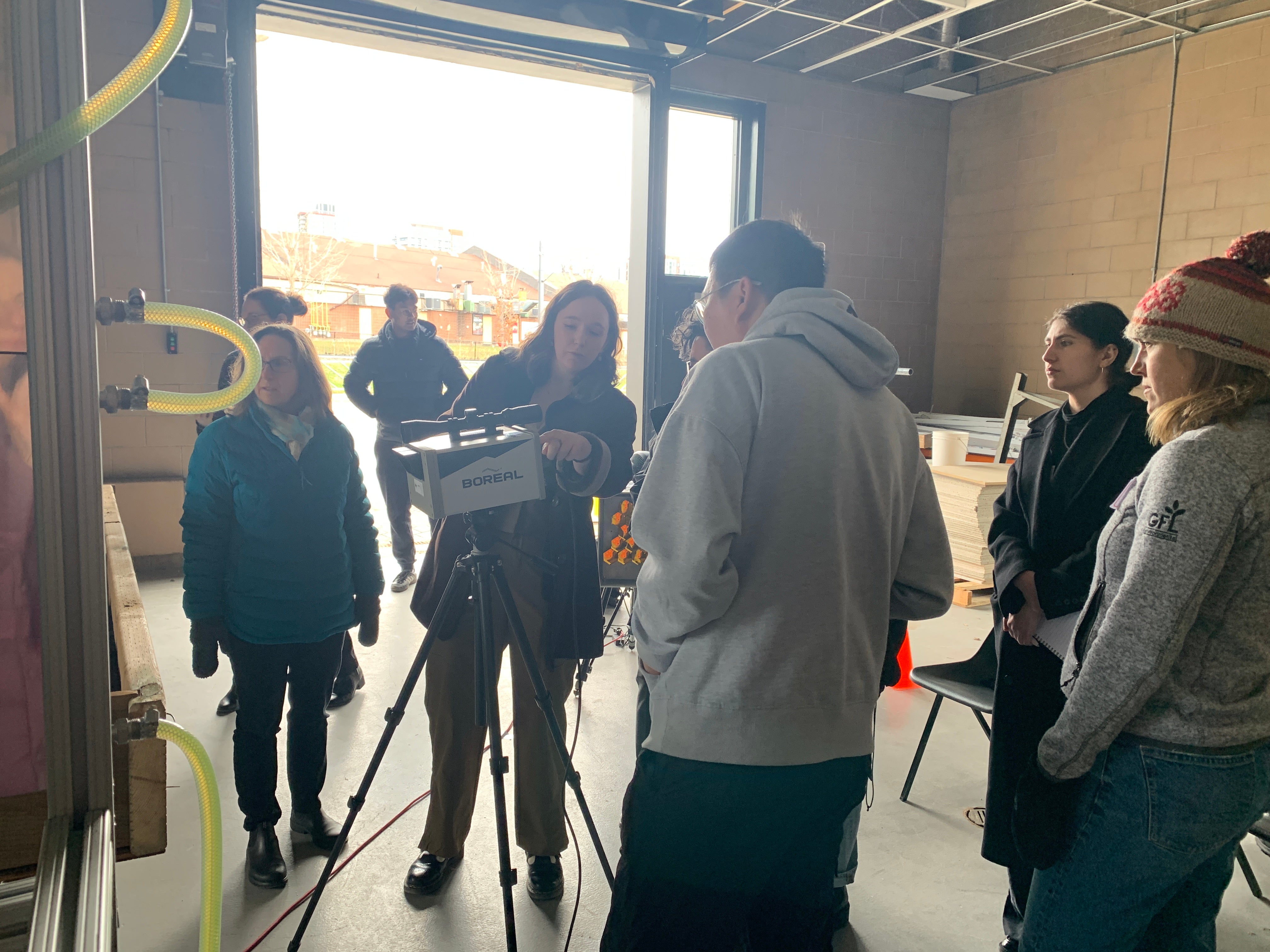 Team member Avery Opalka points to data being captured on the TDLAS system.