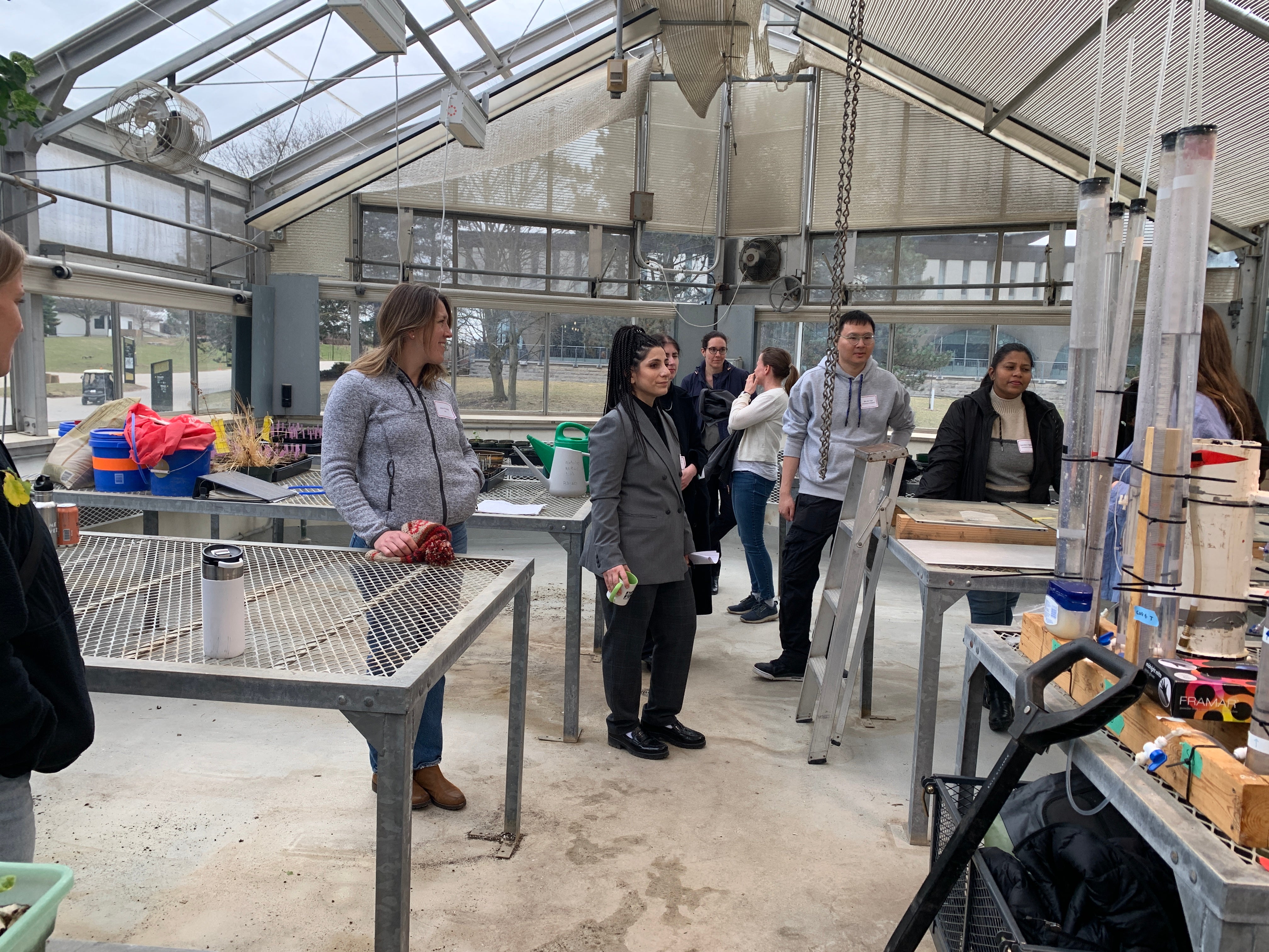 Workshop participants inside the campus greenhouse.