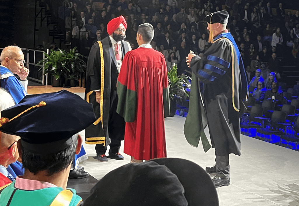 Avery on stage at convocation