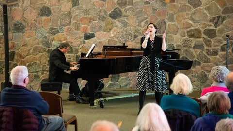 noon-hour concert with a person singing and other person playing piano