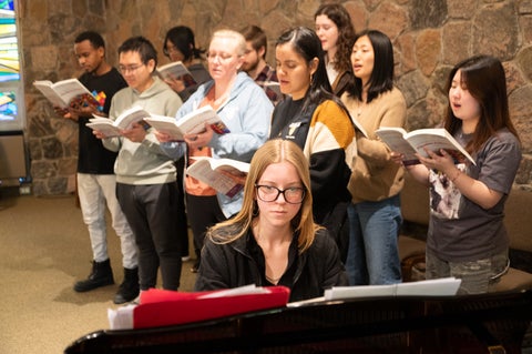Pianist with chapel choir behind