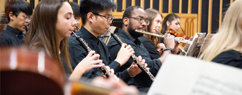 Students play in the wind section of the uwaterloo orchestra