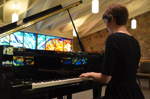 Nicole Simon playing piano in chapel