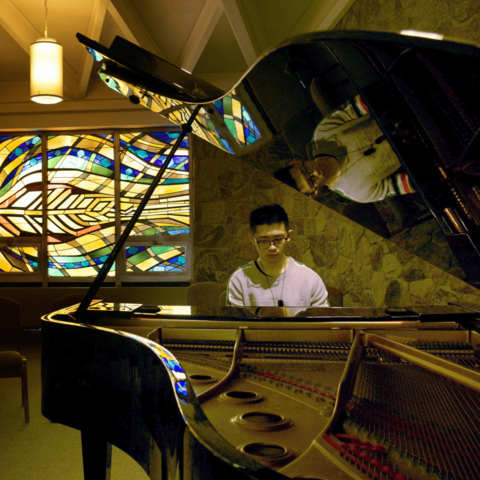 Nicholas Wong playing piano in the Grebel Chapel