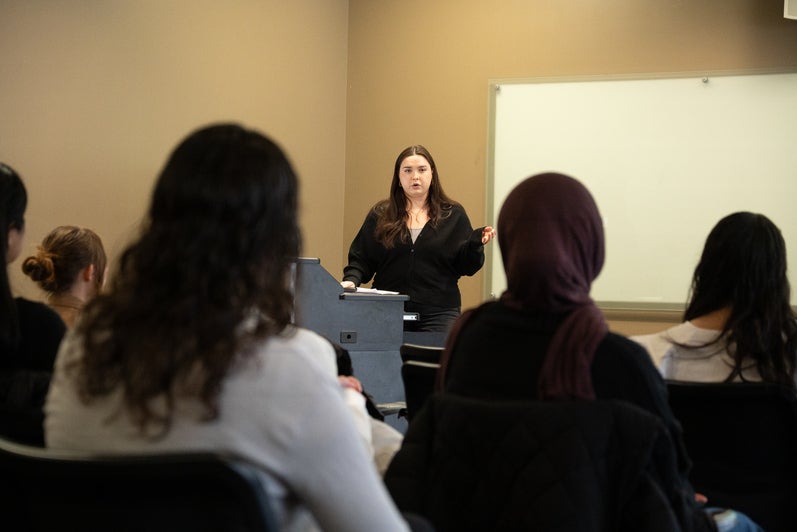 Emma Liske talking to group of people