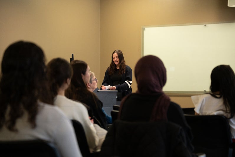Tessa Nazaruk standing at podium speaking to a group