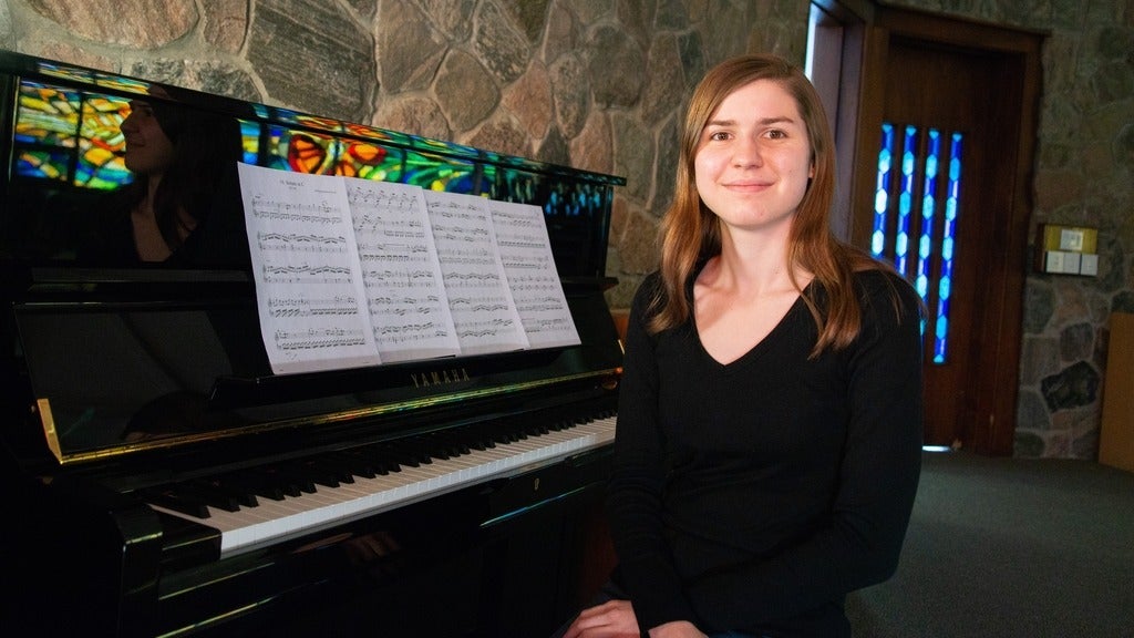 Leah Dau sitting at the piano in the Grebel Chapel