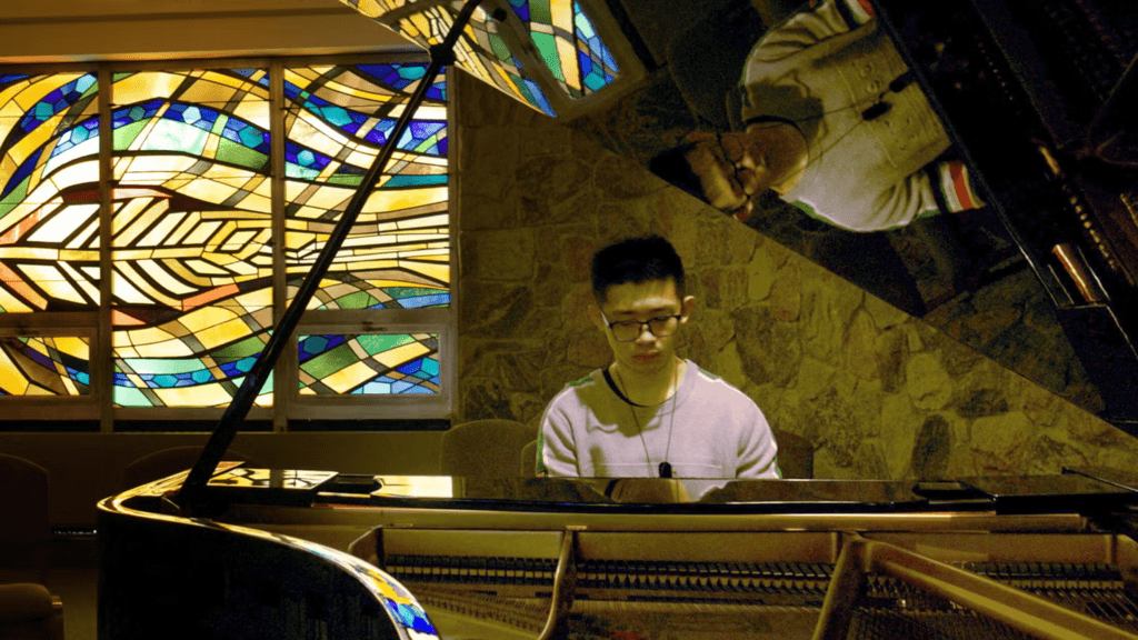 Nicholas Wong playing piano in the Grebel Chapel