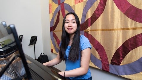 Jewel sitting at a piano