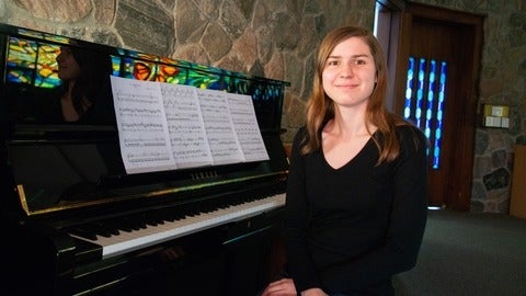 Leah Dau sitting at the piano in the Grebel Chapel