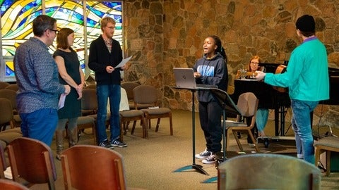 Students singing in chapel