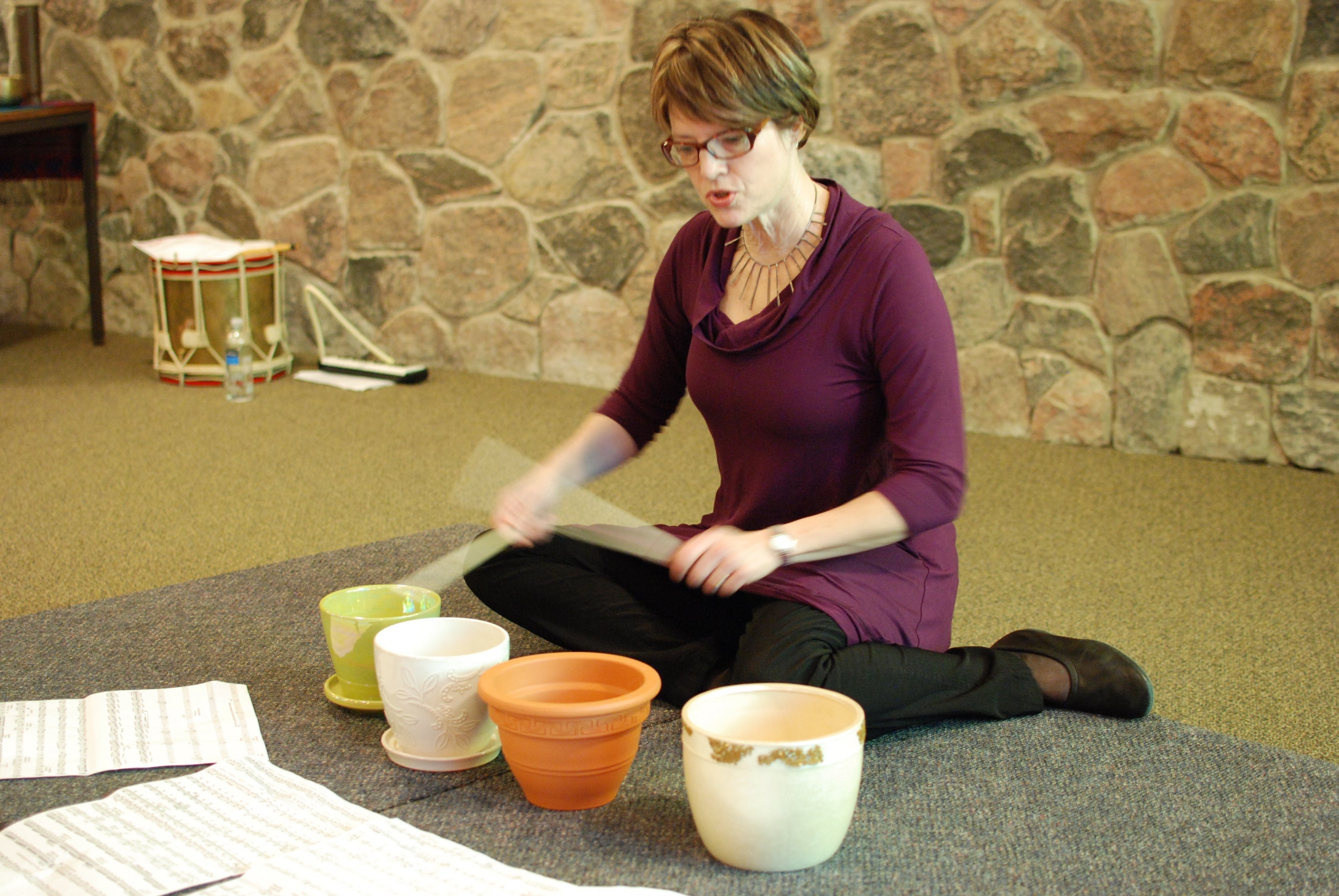 woman playing flower pots as percussion instrrument
