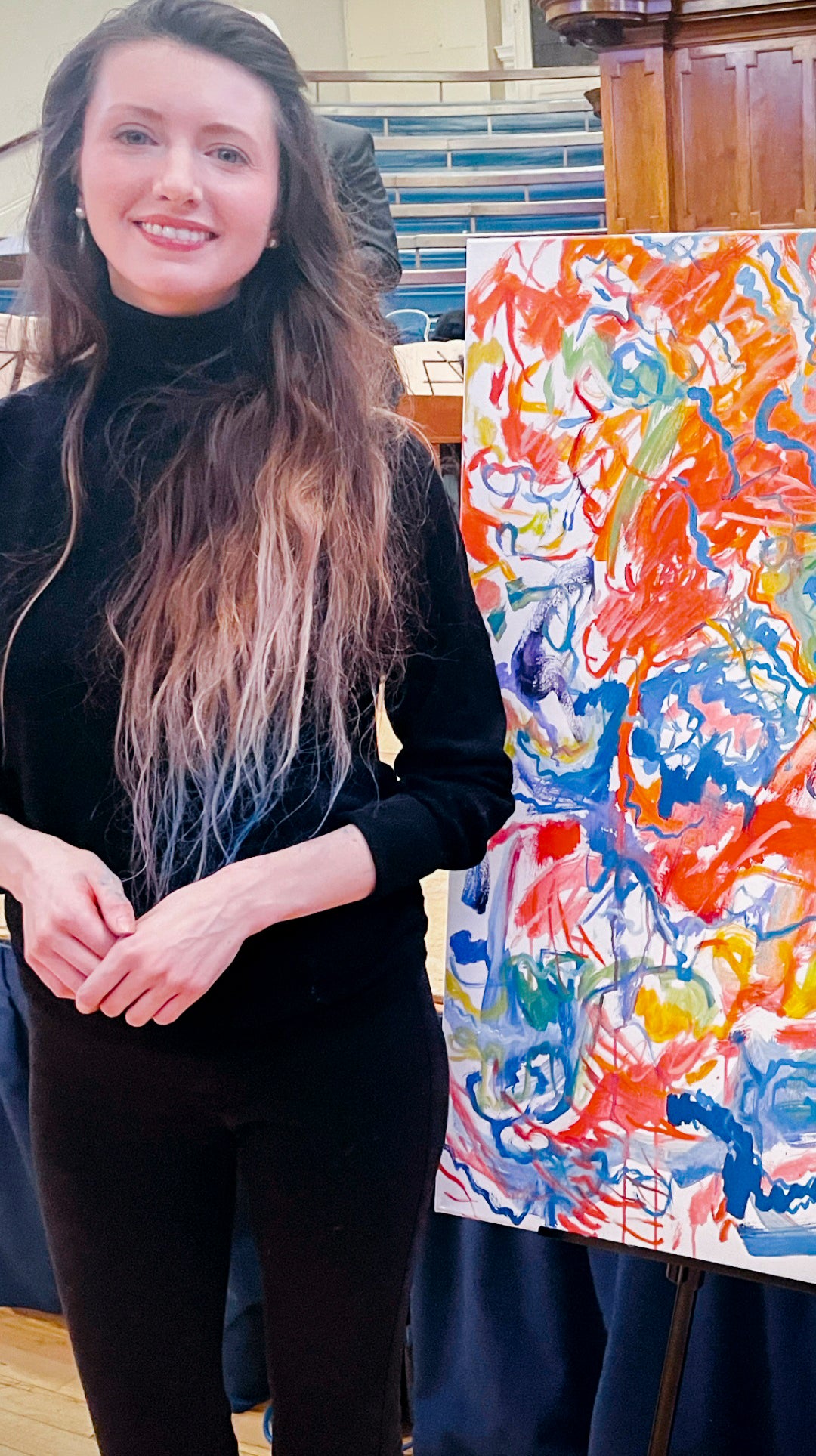 Caroline Bordignon beside her painting to live music