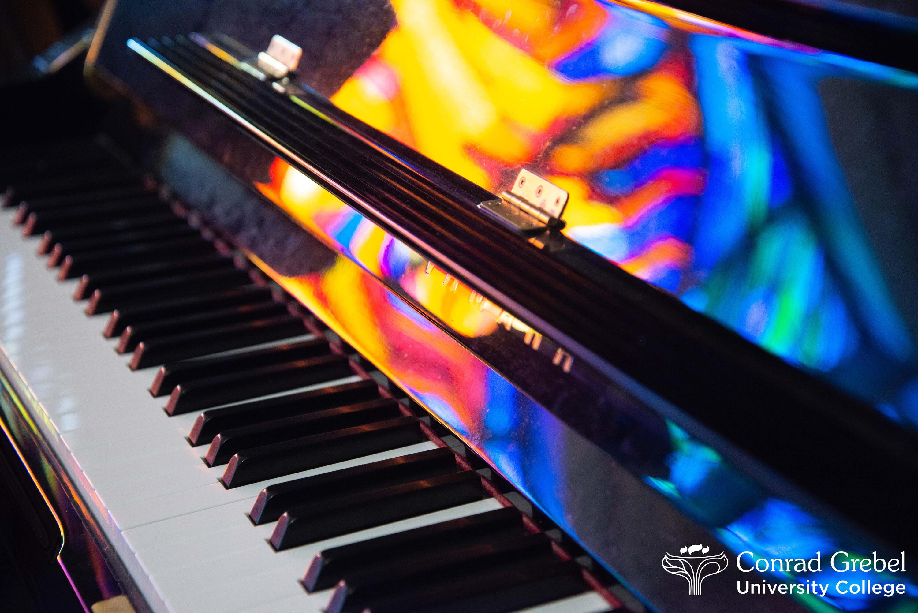 Grebel piano with stain glass reflections