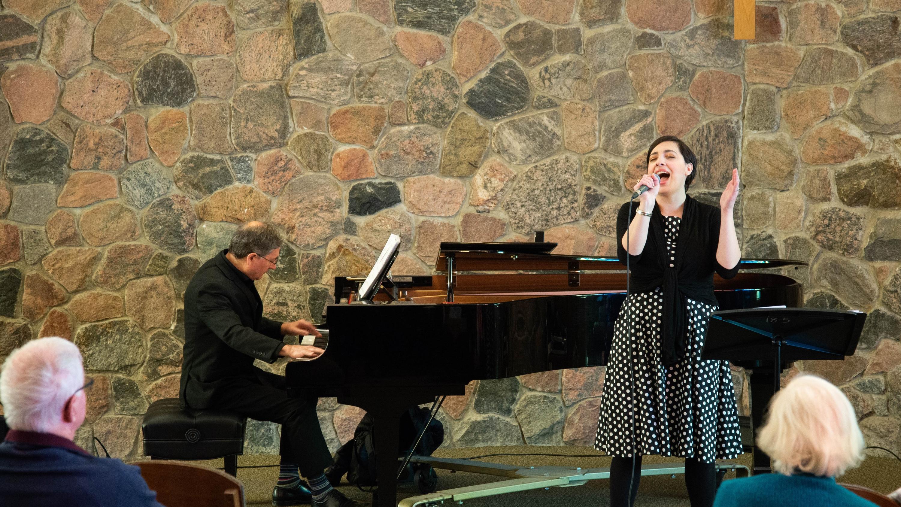 Mary-Catherine sings while paul stouffer plays piano